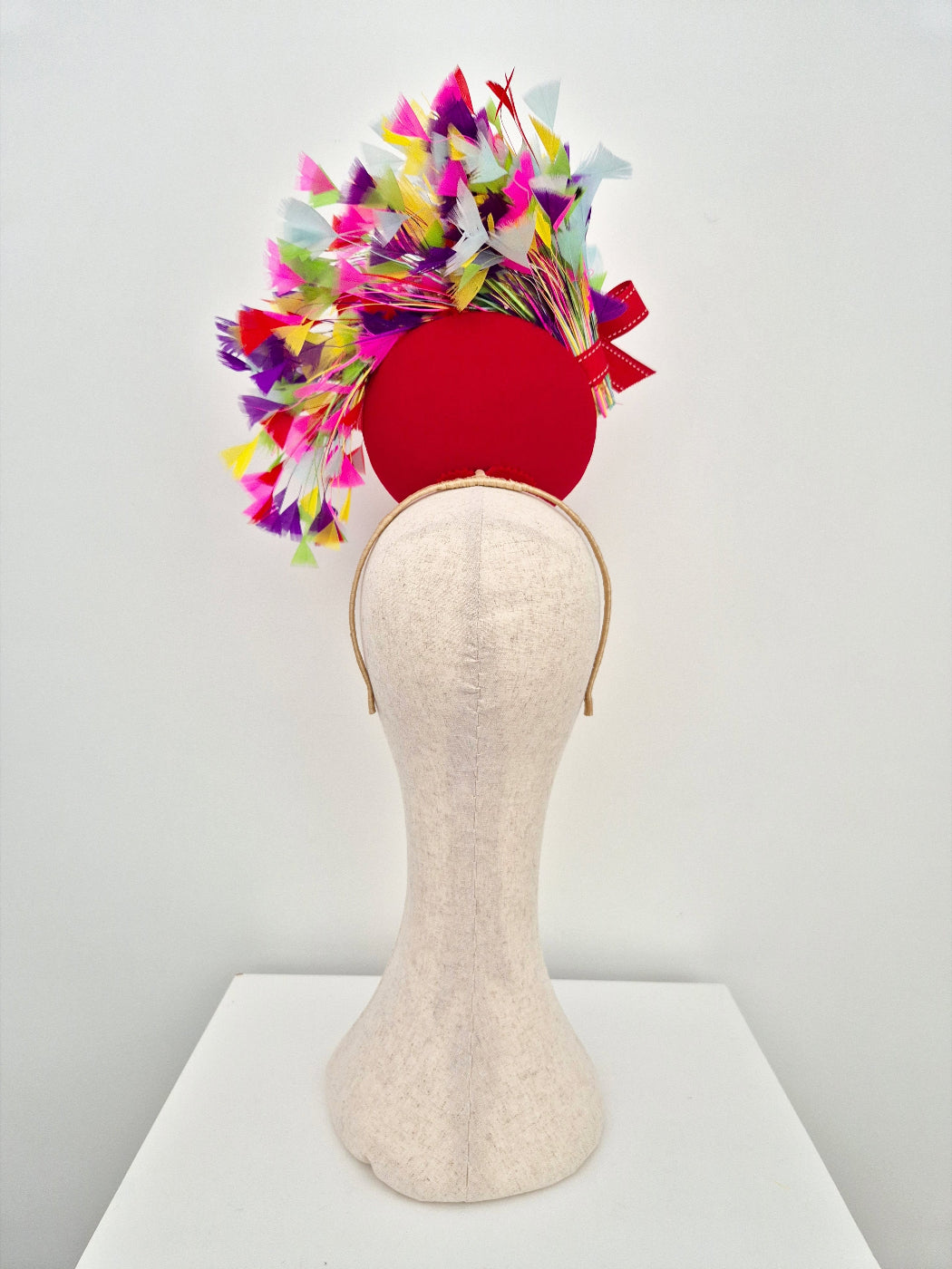 back view red percher headpiece with multi coloured feathers