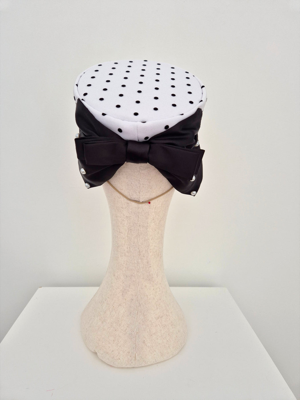 black and white polka dot pillbox headpiece with bow back view