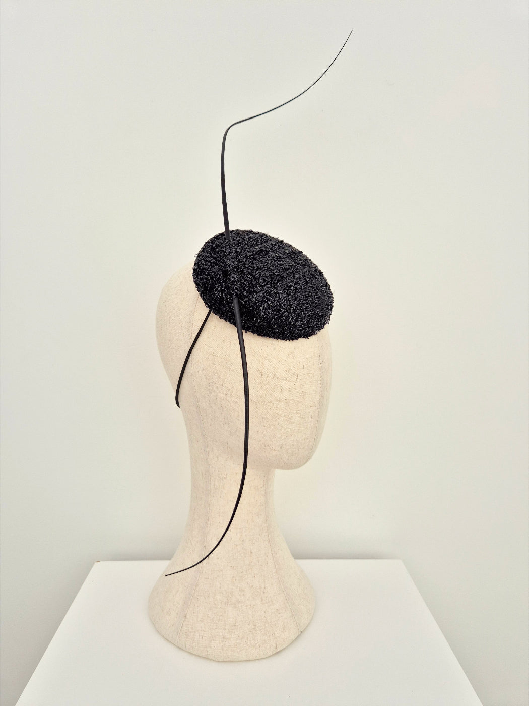 black button headpiece with quills side view