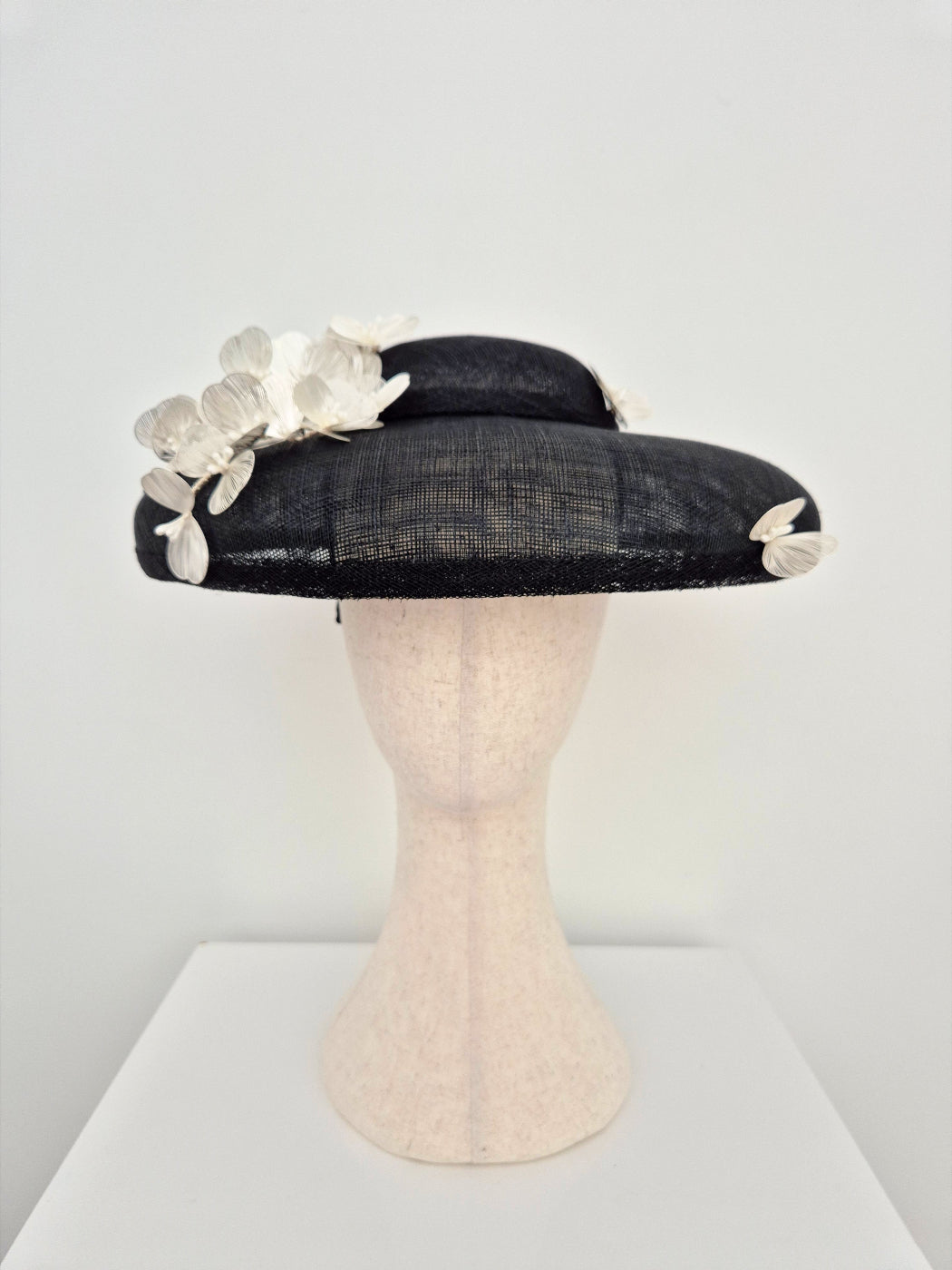 black dior style straw hat with silver white flowers