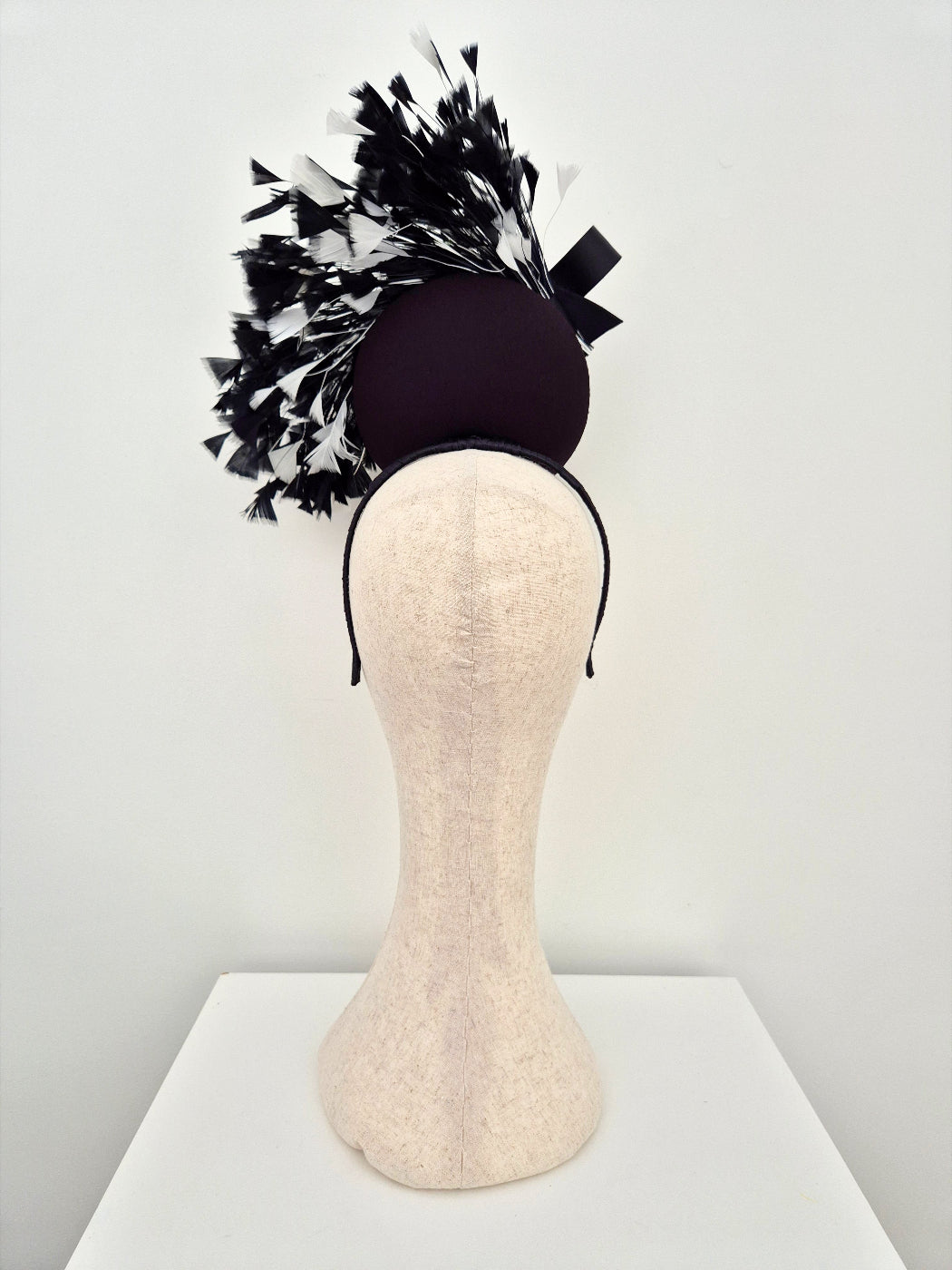 black headpiece percher with black and white feathers back view