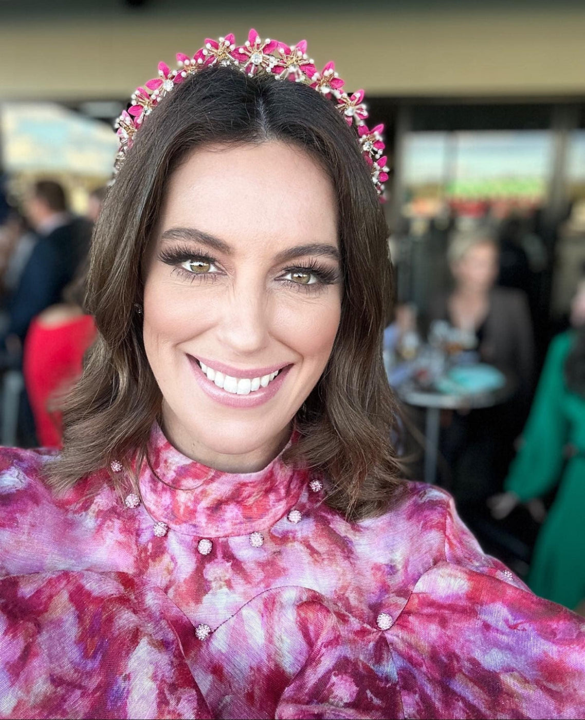 client wearing hot pink flower headpiece