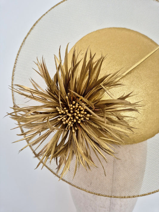 close up gold percher with feather flower
