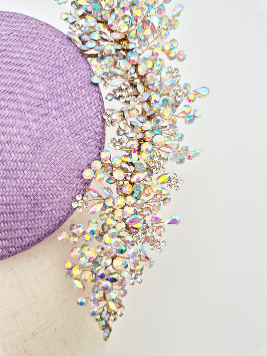 Purple straw hat with a decorative crystal band on a white background