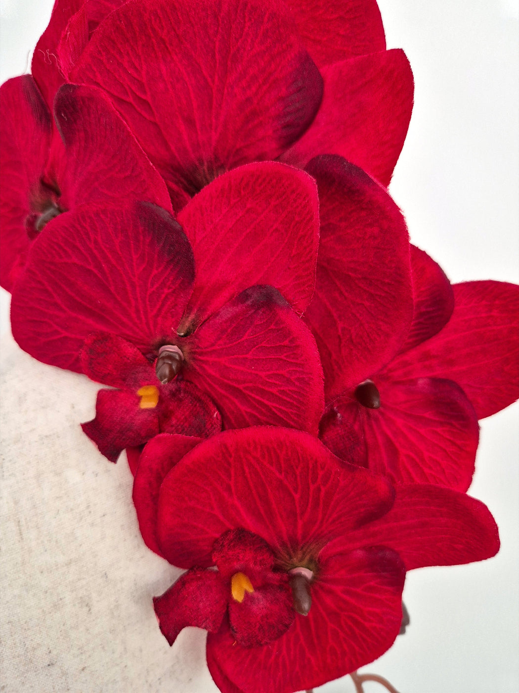 close up red floral orchid headpiece