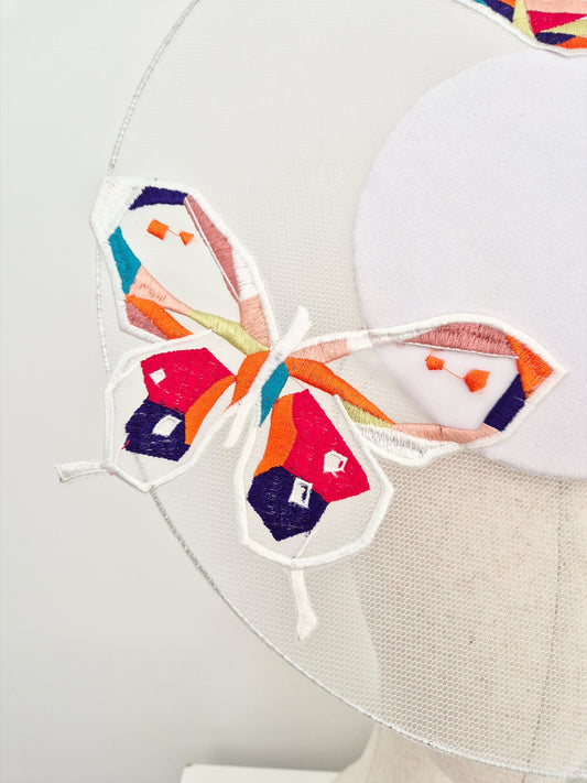 close up white percher headpiece with butterflies