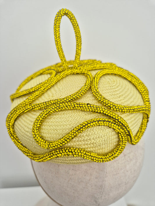 close up yellow button headpiece with rhinestones
