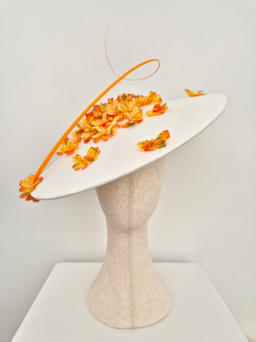 ivory coolie hat with orange petals