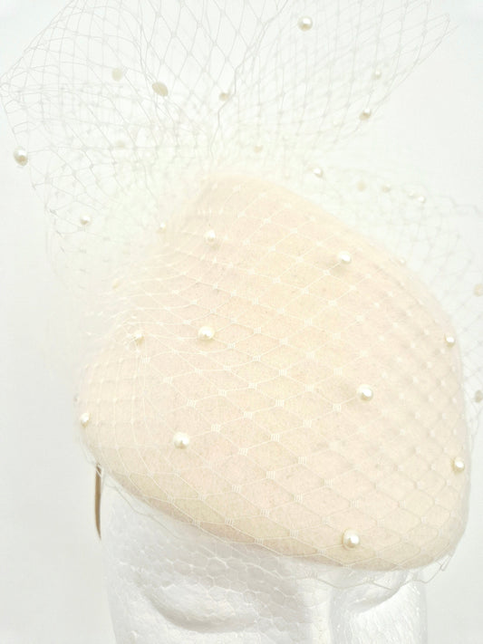 ivory wool topper headpiece with pearls and veiling close up