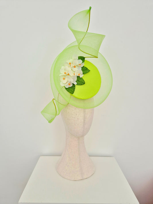lime Green decorative percher headpiece with floral detail on a mannequin head against a white background side front view