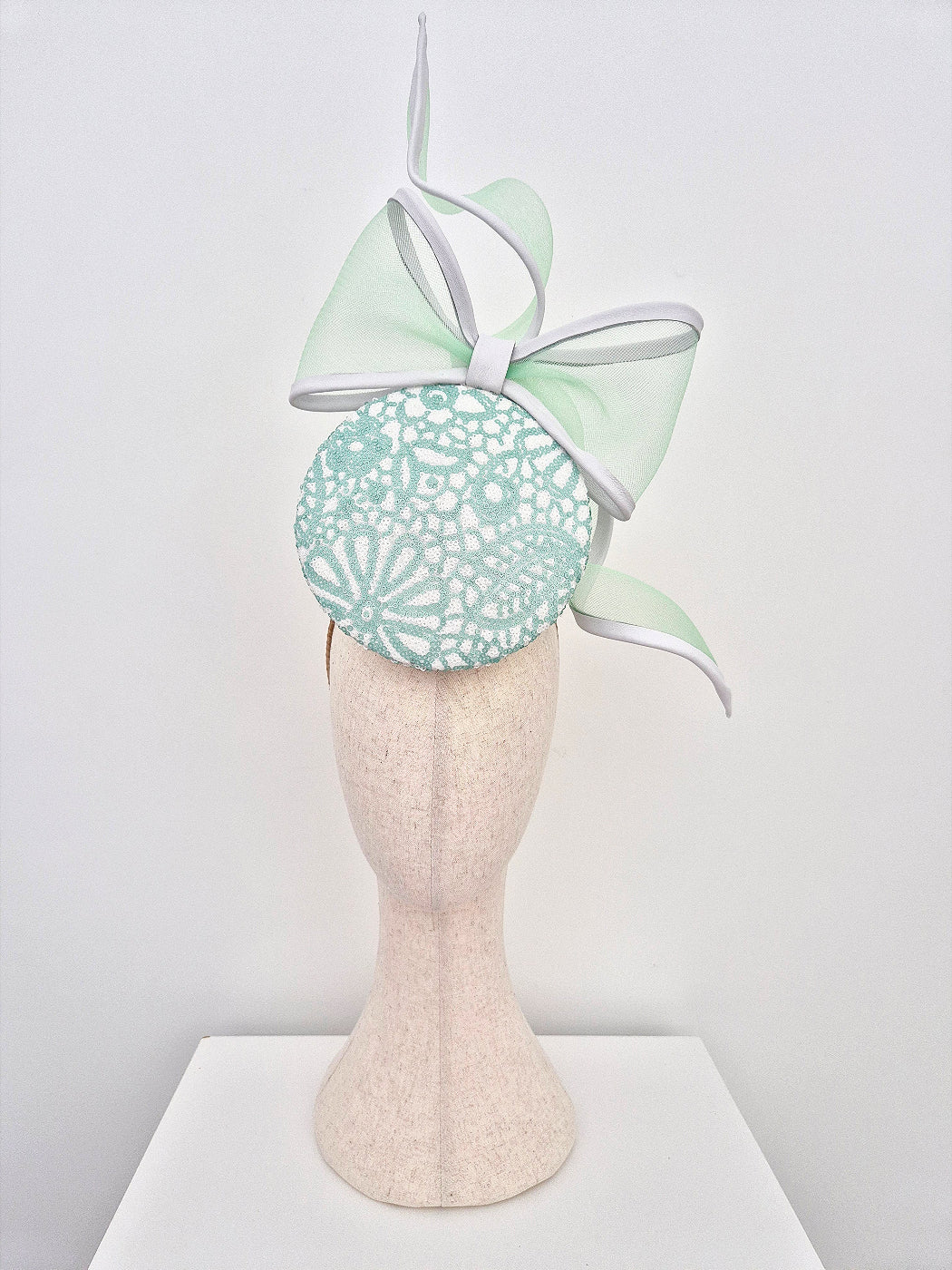 mint green and white sequin percher headpiece with bow