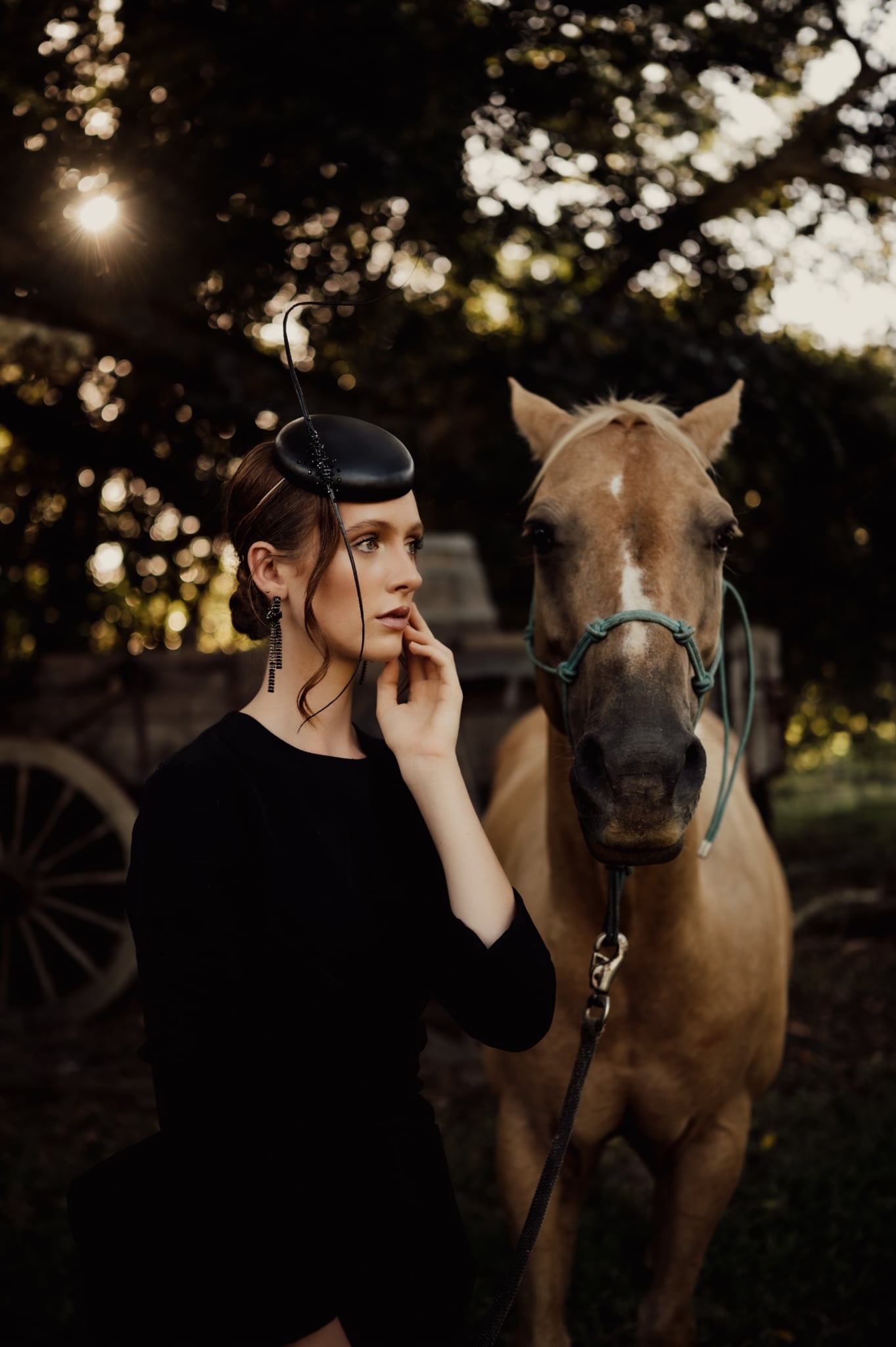 model wearing black leather button headpiece millinery fascinator
