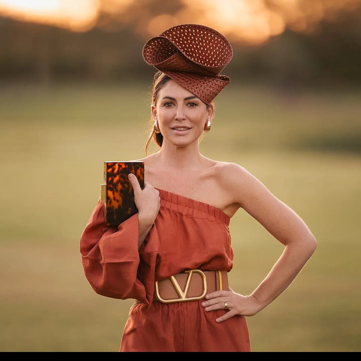 model wearing brown braided straw headpiece