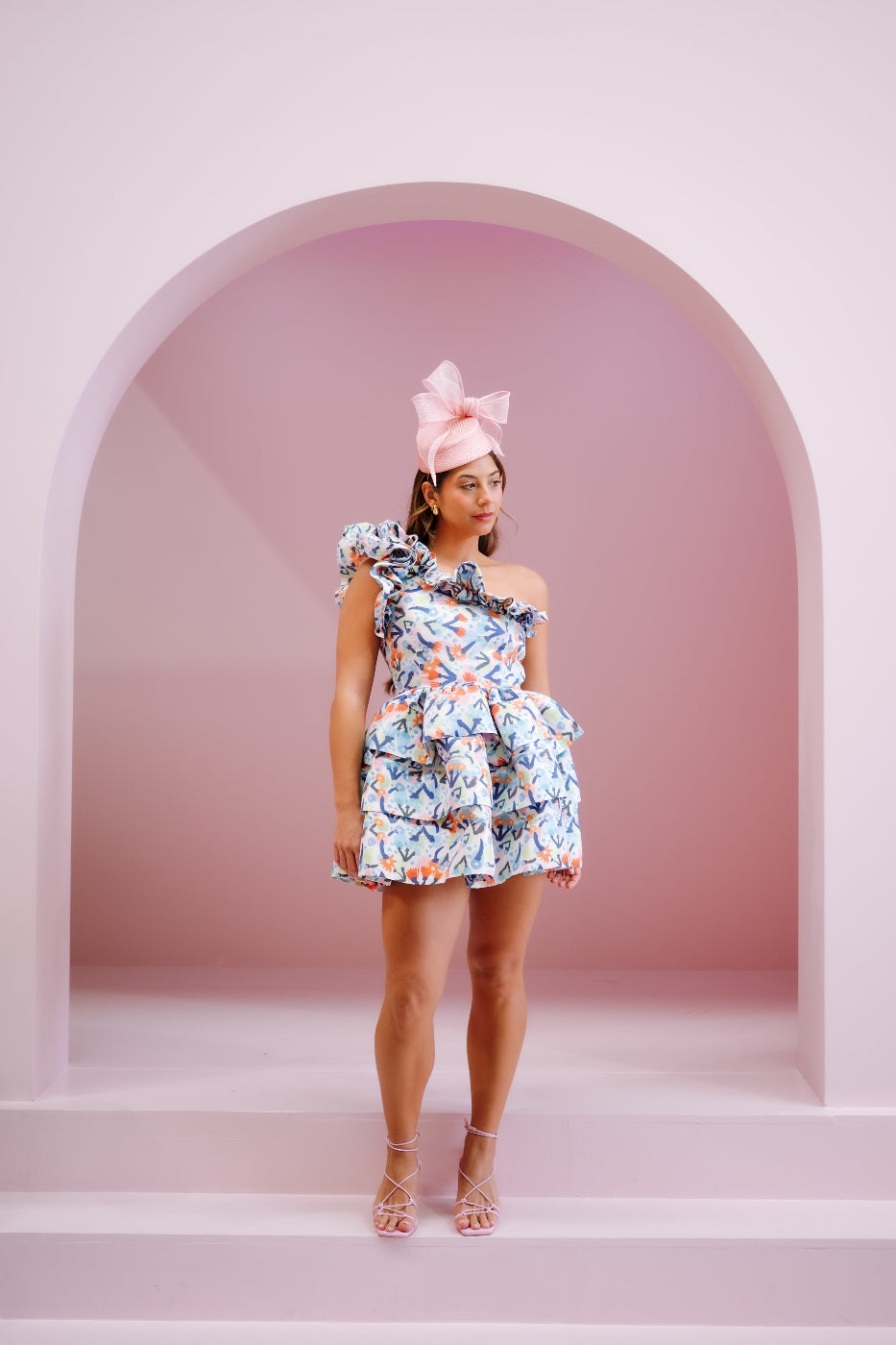 model wearing pink headpiece with bow