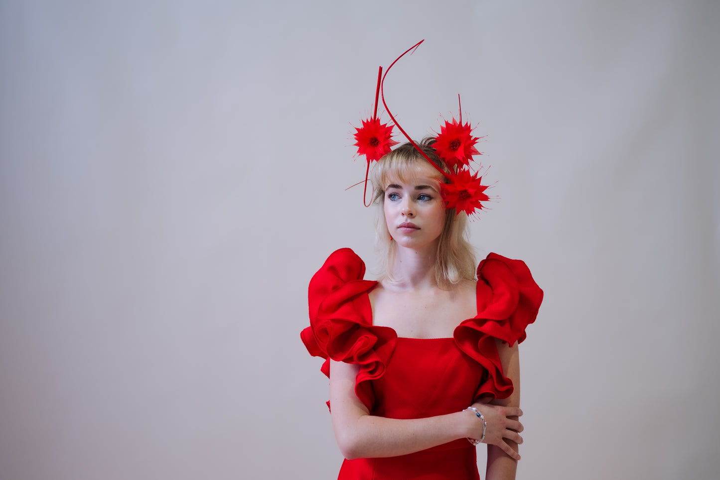 model wearing red floral flower headpiece