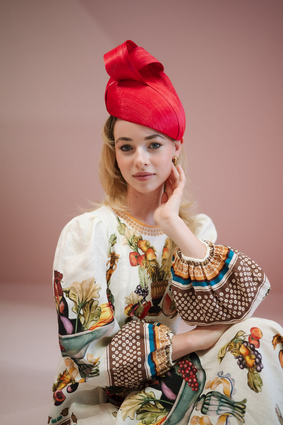 model wearing red silk headpiece