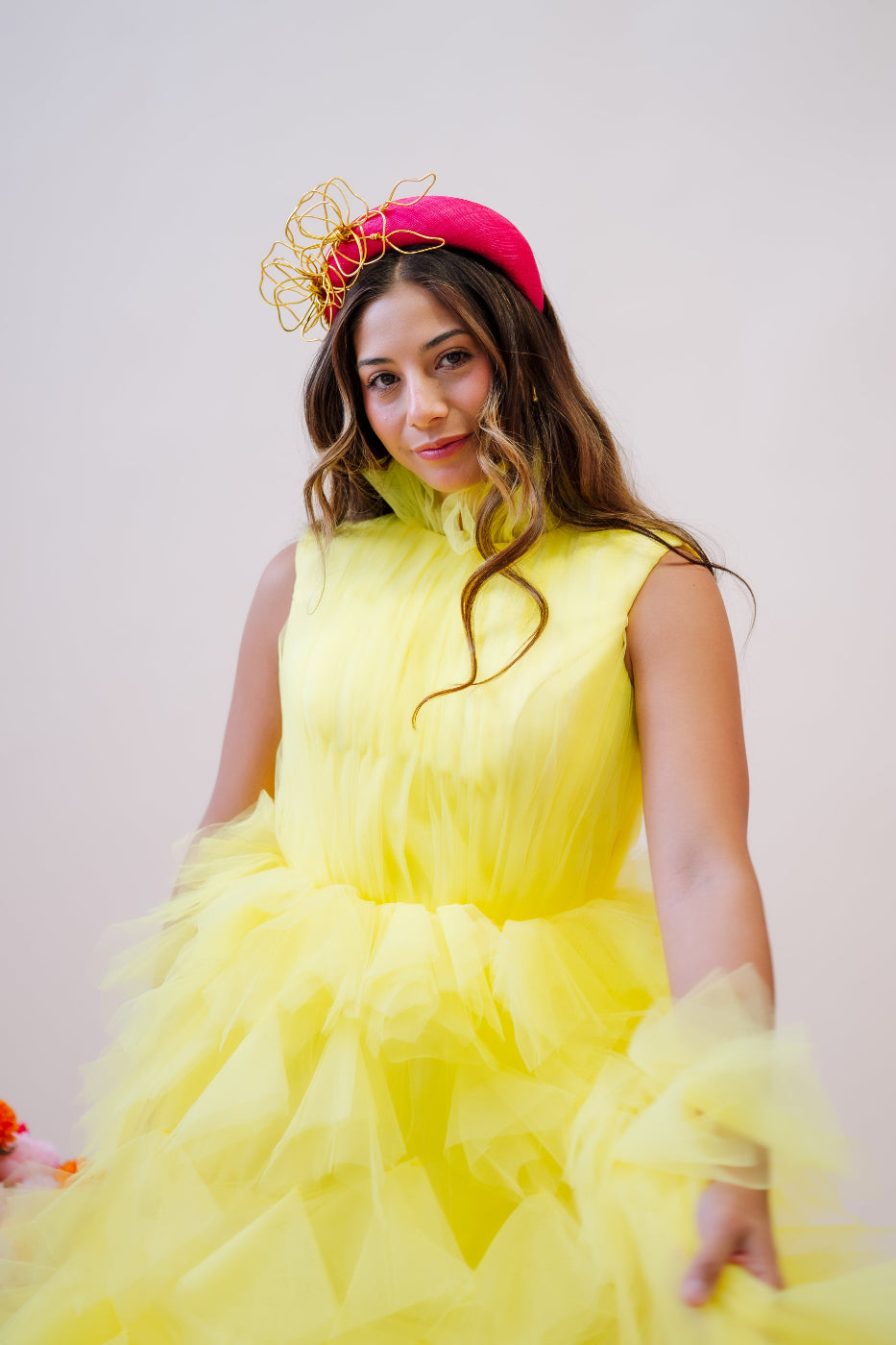 model wearing straw headpiece with wire flowers