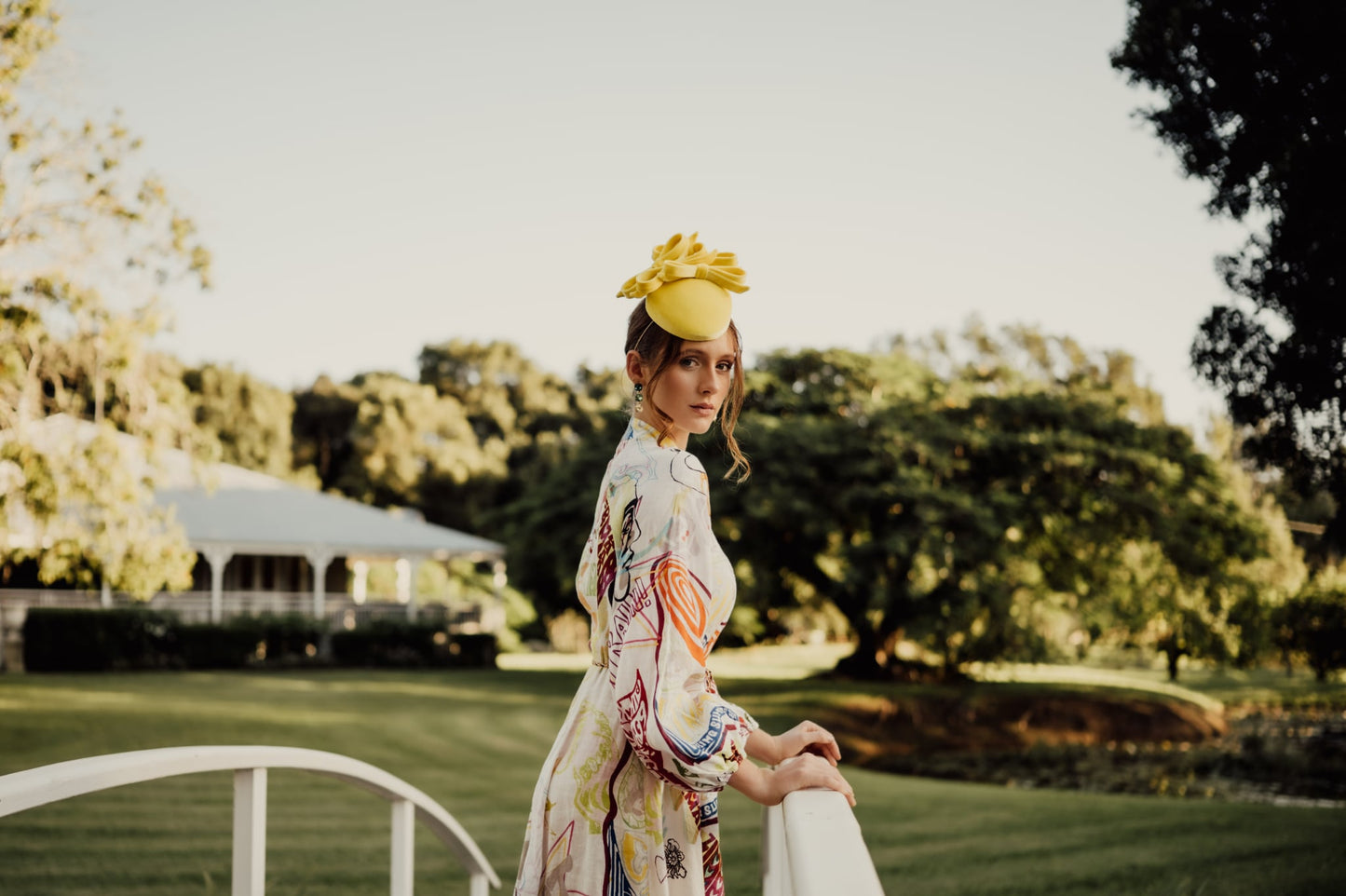 model wearing yellow headpiece fascinator millinery