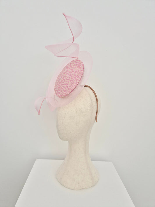 pink and cream percher headpiece on a manniquin head against a white background side view