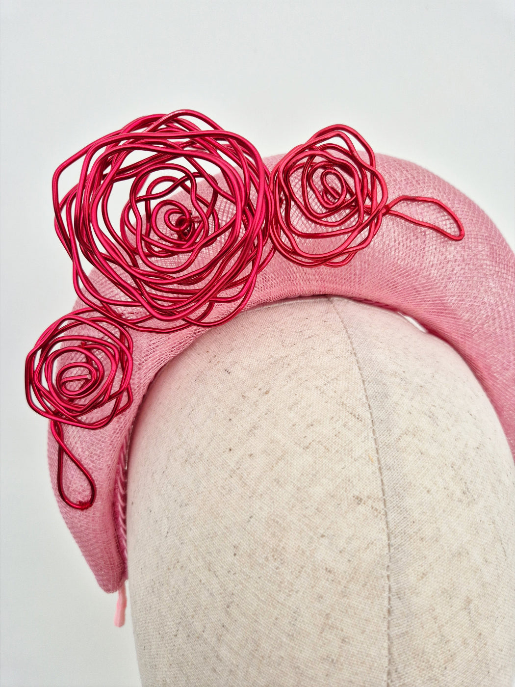 pink straw halo headpiece with red wire work roses close up