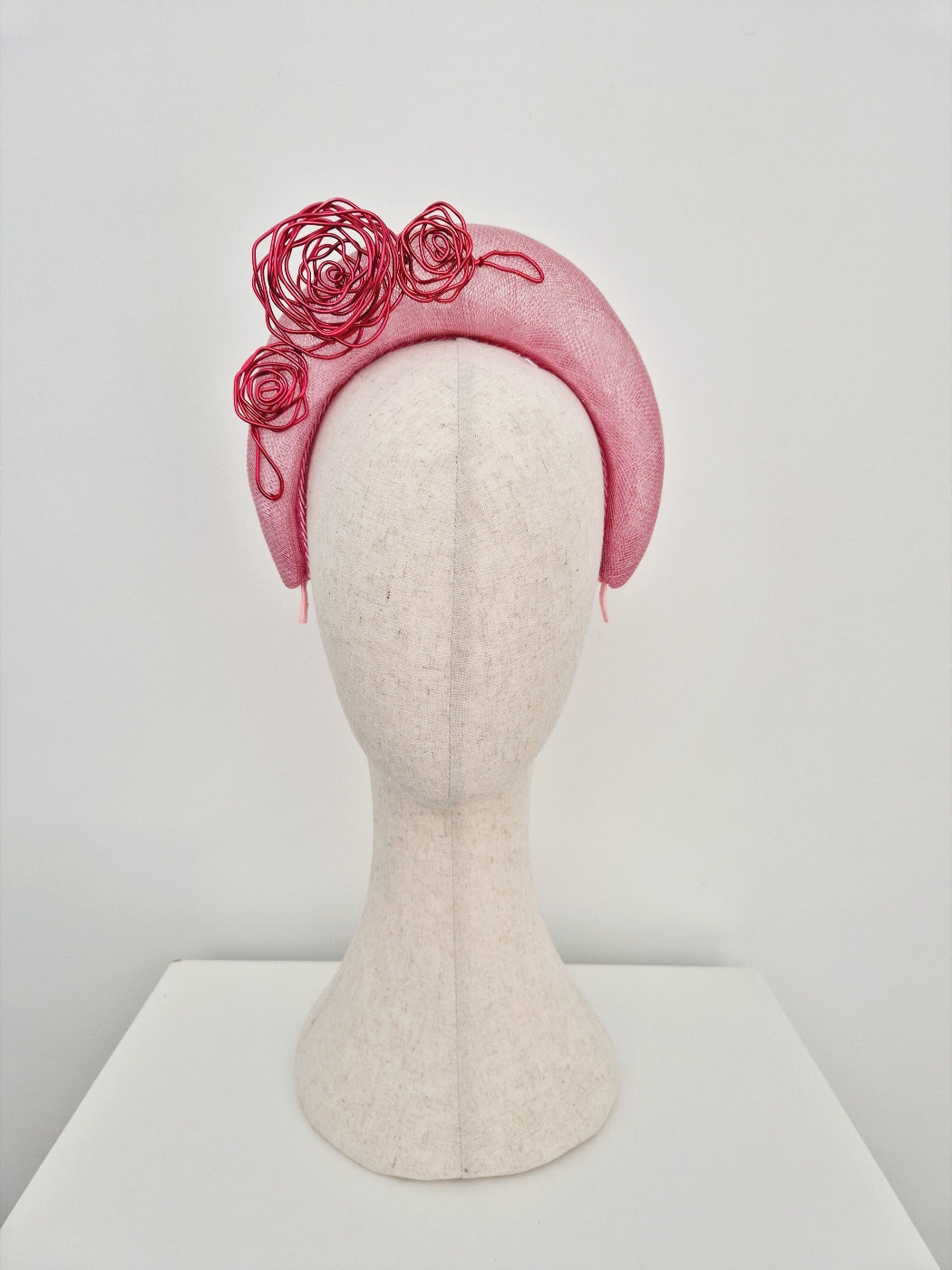pink straw halo headpiece with red wire roses