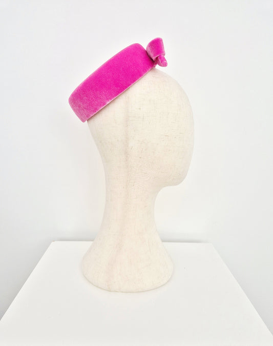 Pink headpiece on a mannequin head against a white background side view