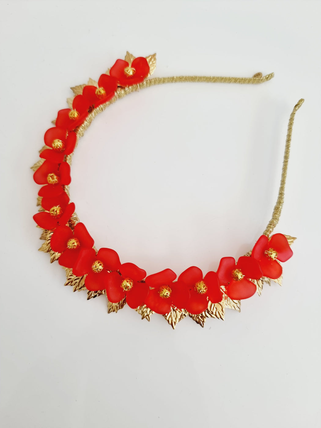red and gold floral headband flat lay