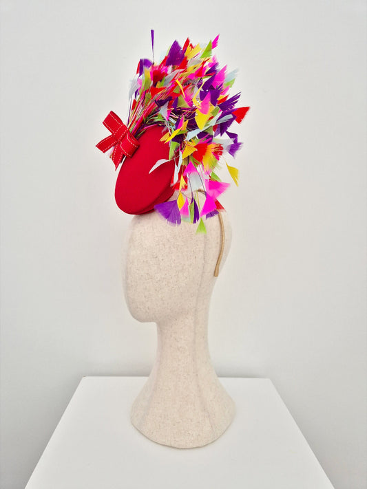 red percher headpiece side view with multi coloured feathers