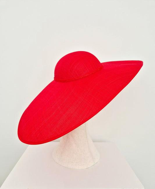 A bright red wide-brimmed straw hat displayed on a white mannequin stand against a clean white background. side back view