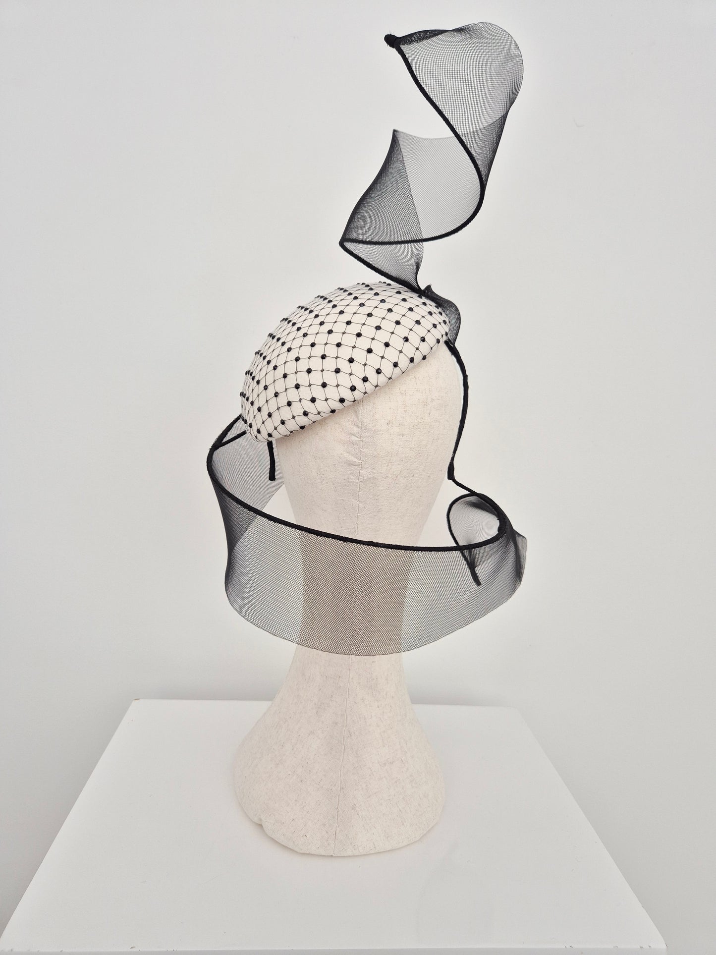 Miss Mabel. Womens Ivory and black felt headpiece with crinoline swirl