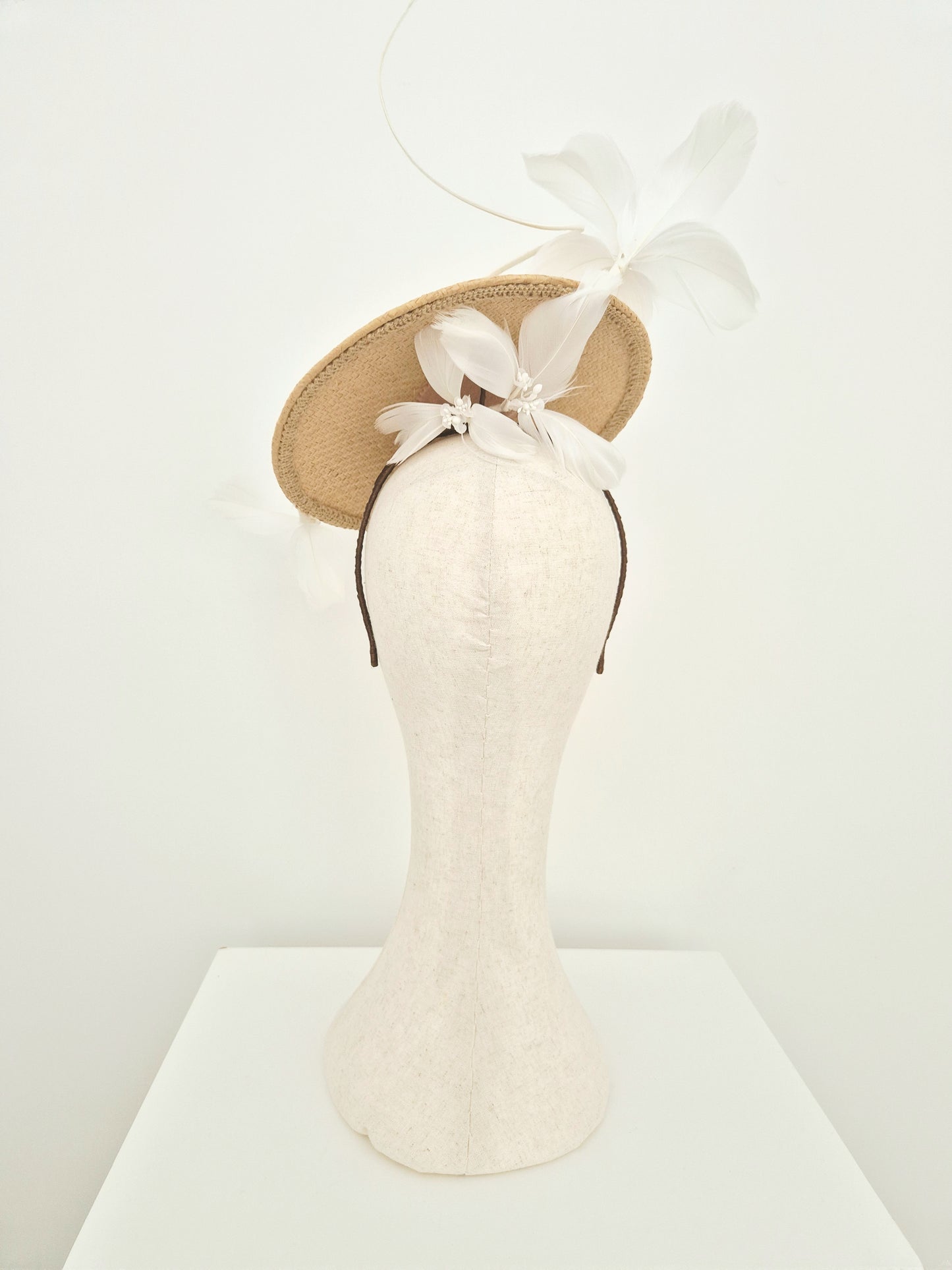 Miss Blair. Womens natural straw disk headpiece with white feather flowers