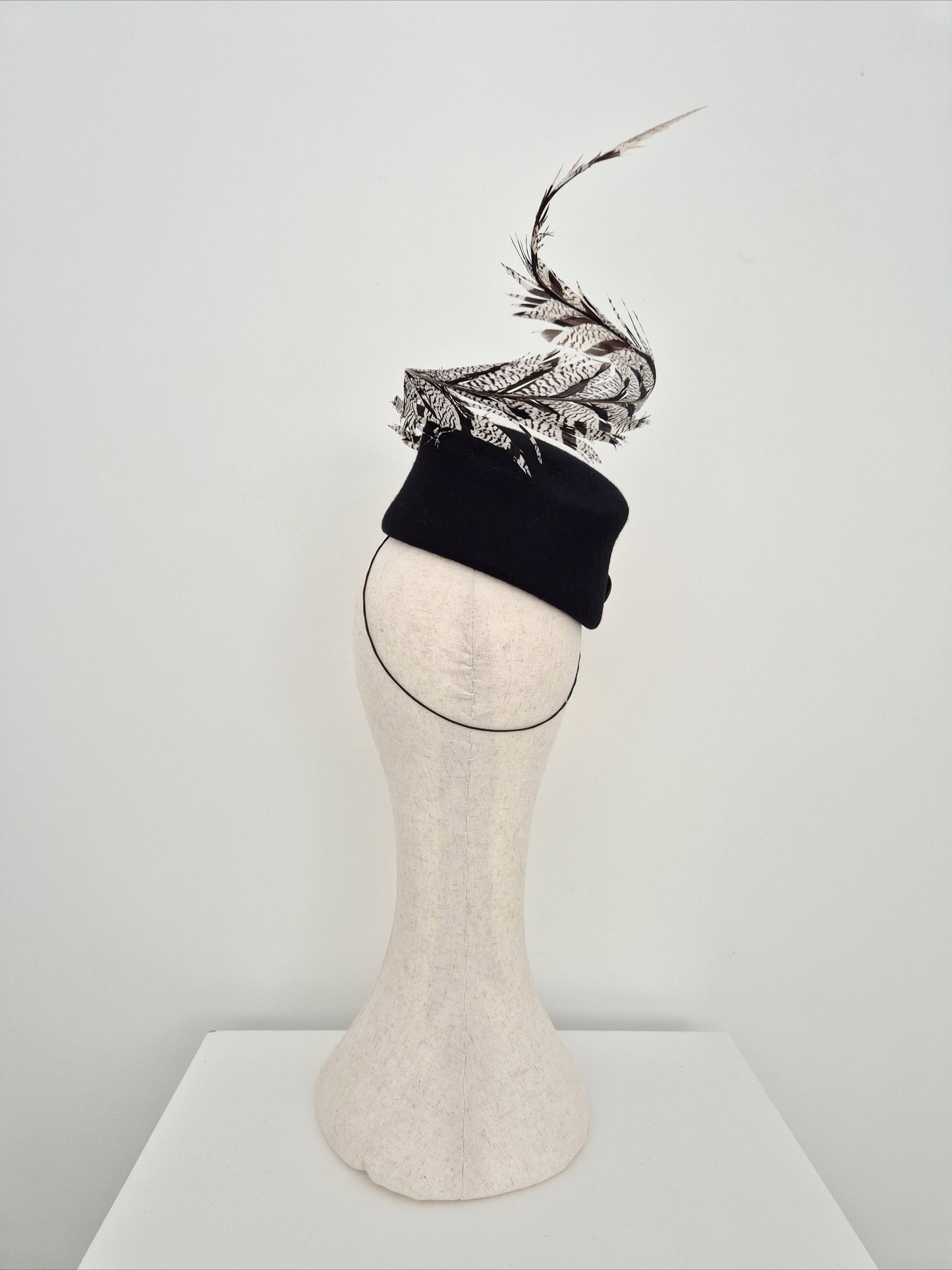 Miss Agatha. Womens black felt headpiece with spiral feather