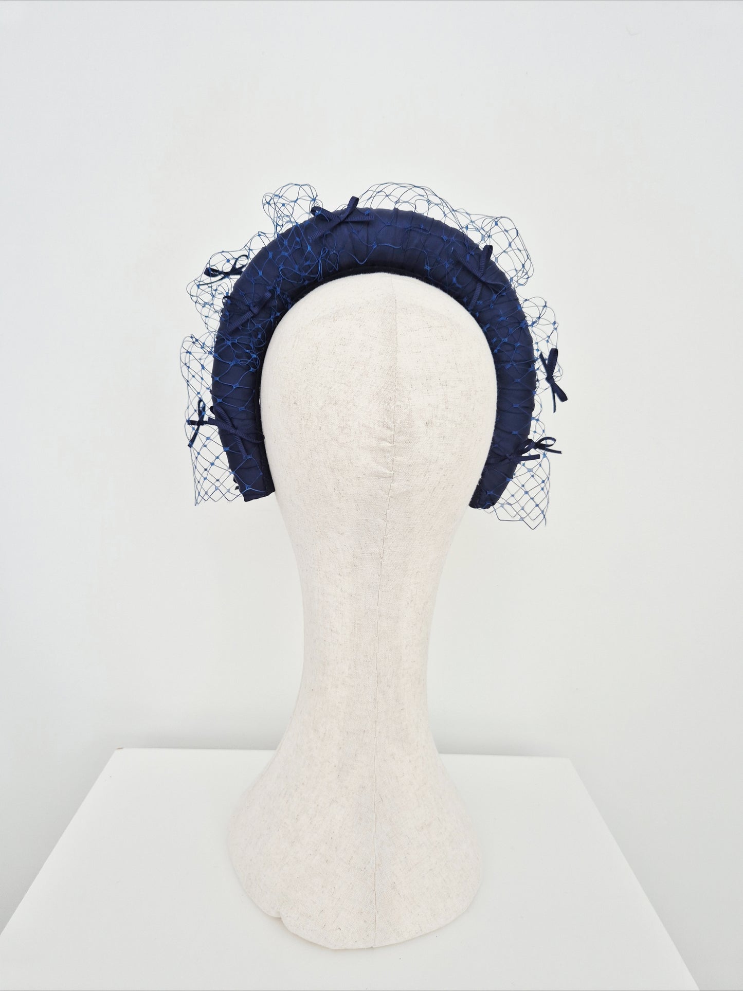 Miss Maria. Womens Navy Blue padded headband with veiling and bows