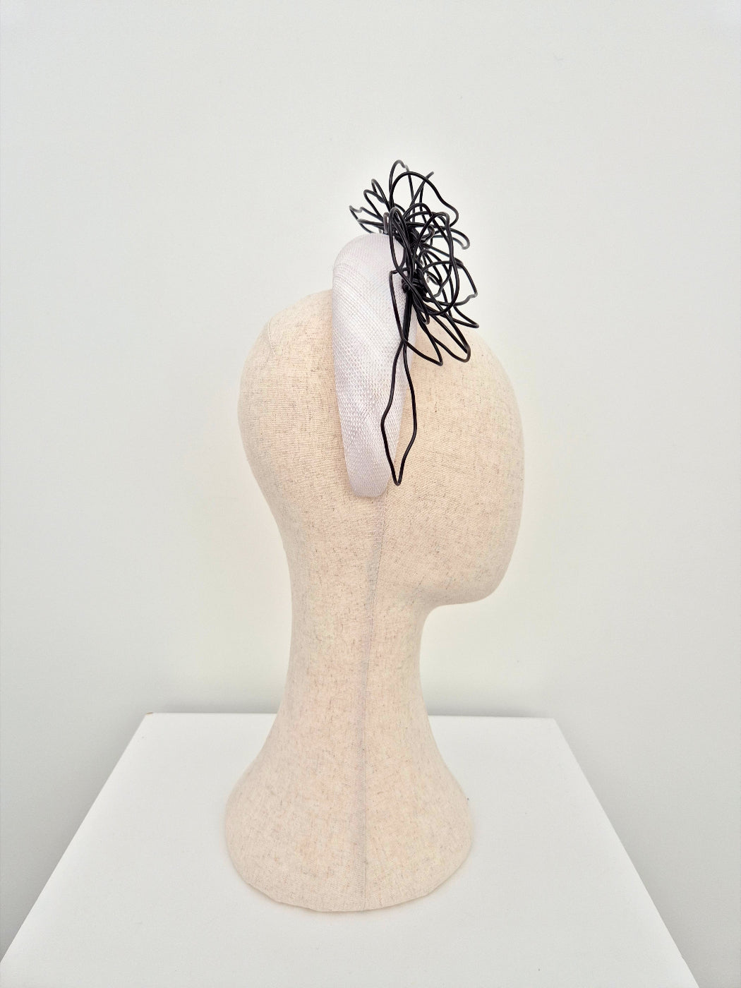 white straw padded headband with black floral wirework side view