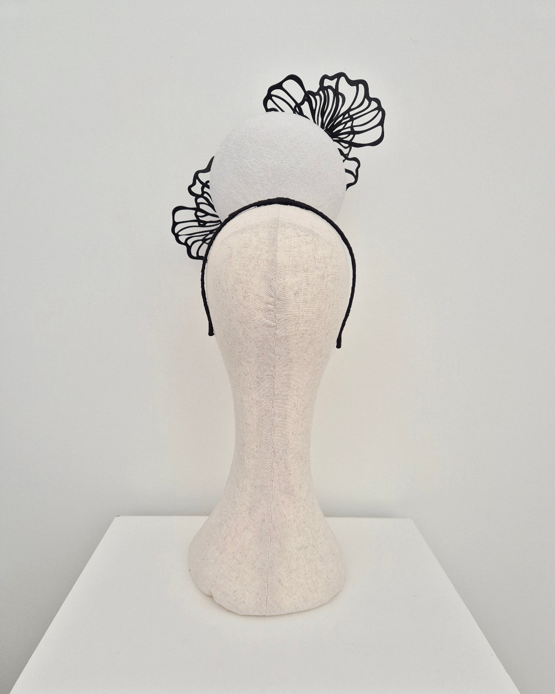 white percher headpiece with black flowers back view