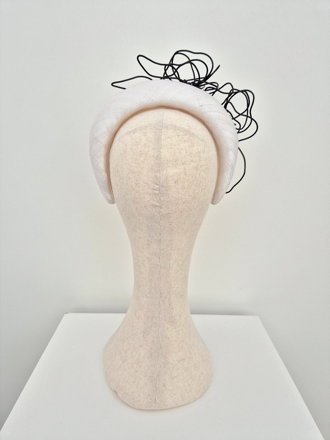 white padded straw headband with black floral wirework back view
