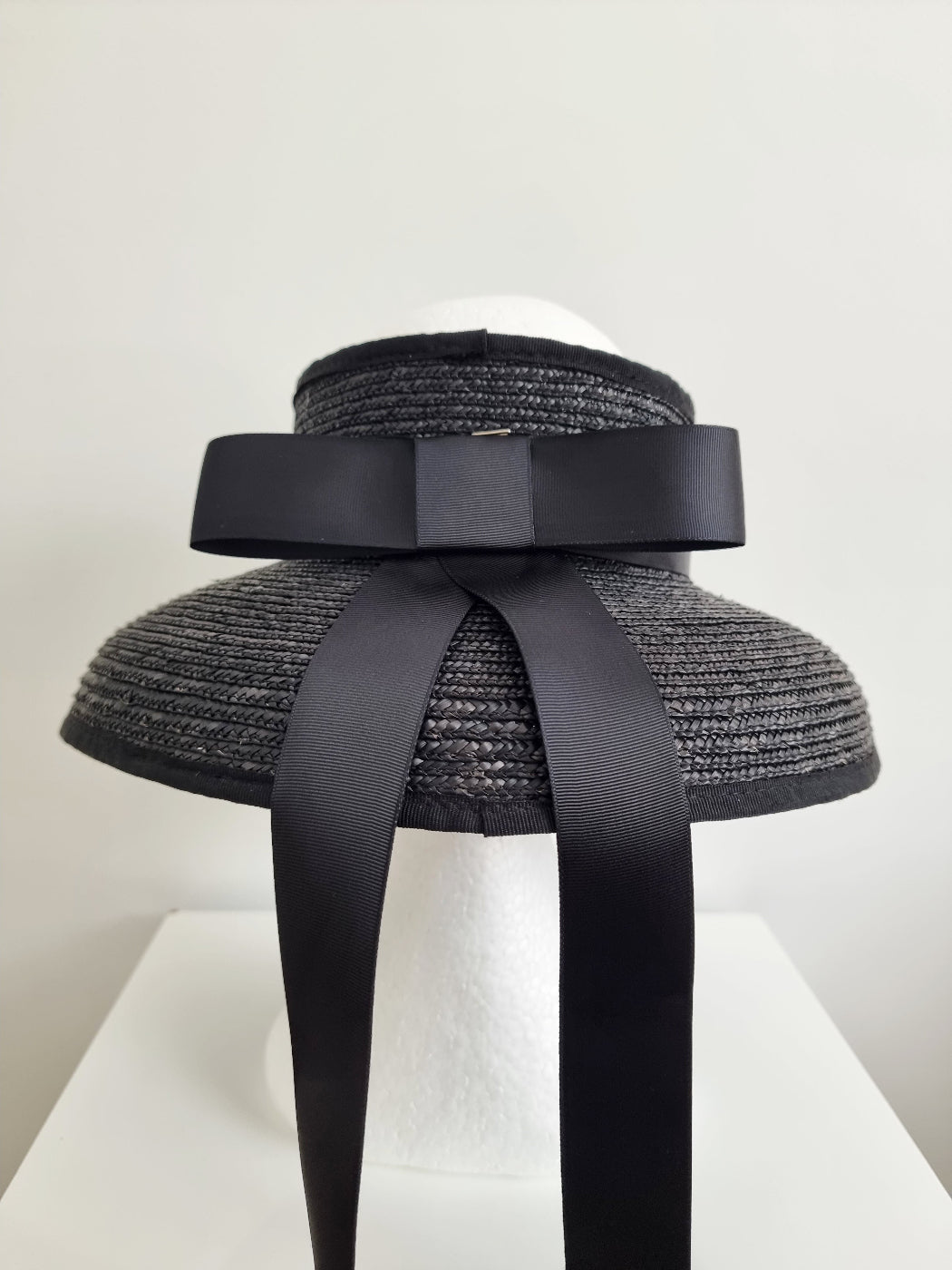 black straw topless hat with bow and tails back view