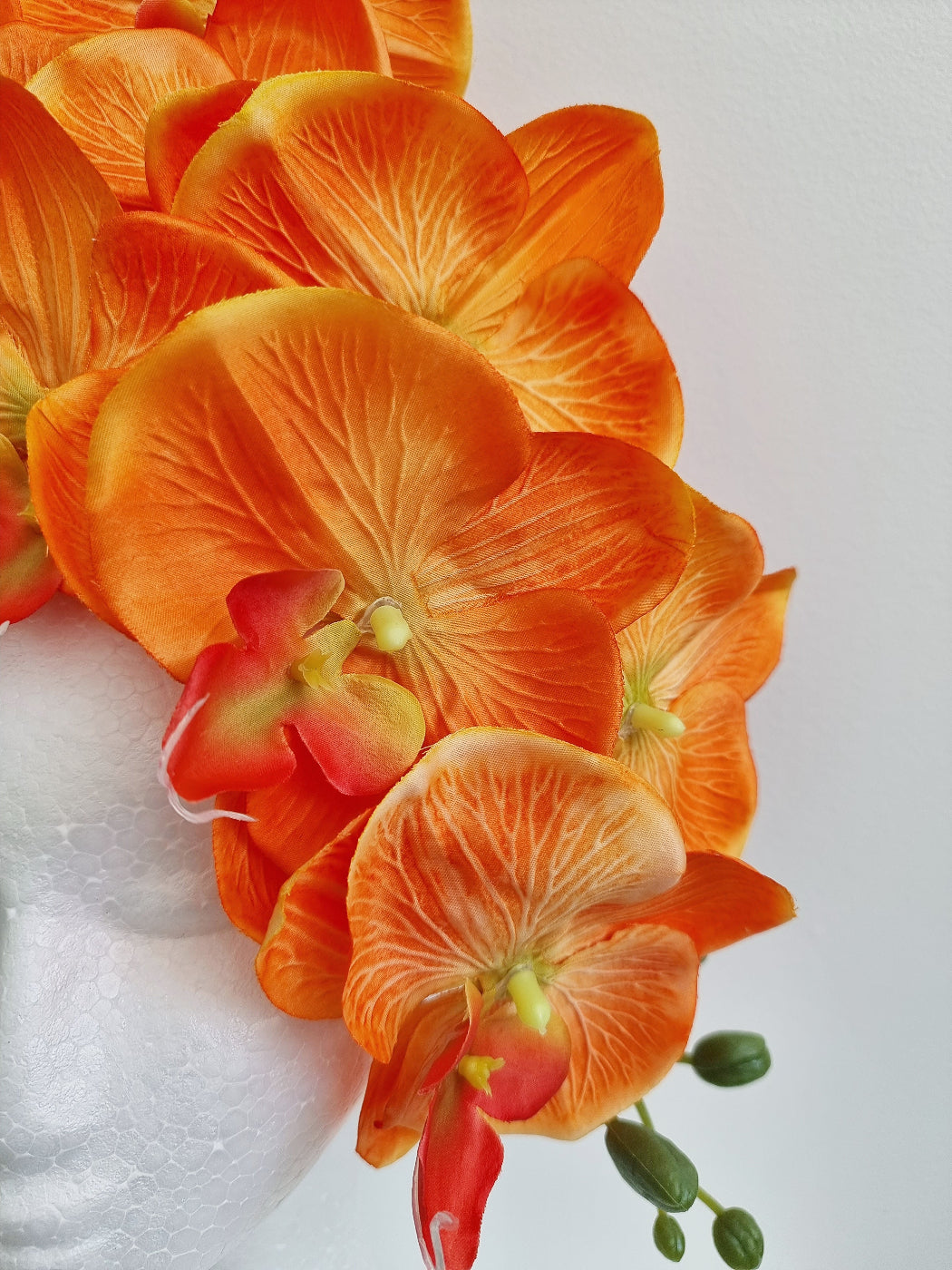 orange orchid headpiece close up