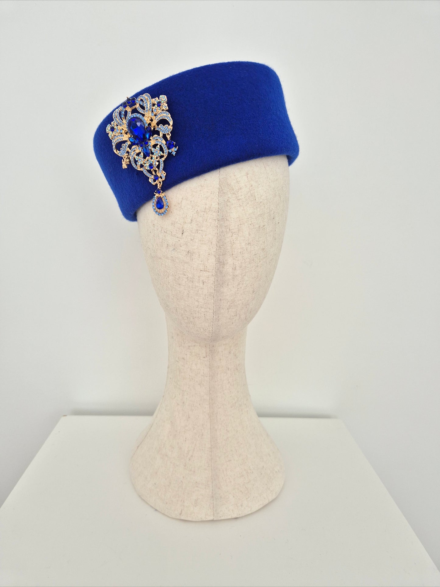Miss Betty. Womens Royal Blue wool felt pillbox headpiece with rhinestone brooch