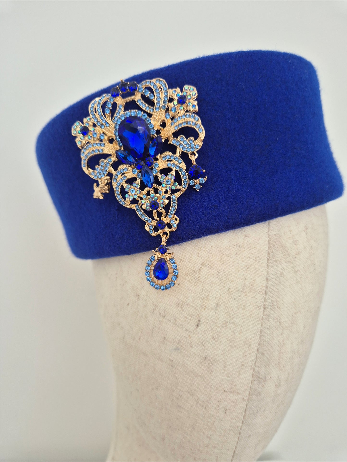 Miss Betty. Womens Royal Blue wool felt pillbox headpiece with rhinestone brooch