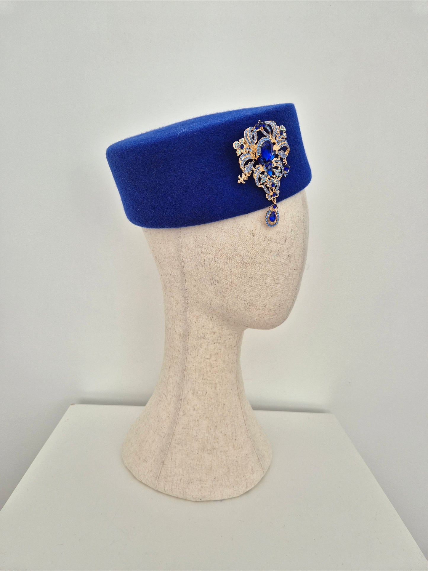 Miss Betty. Womens Royal Blue wool felt pillbox headpiece with rhinestone brooch