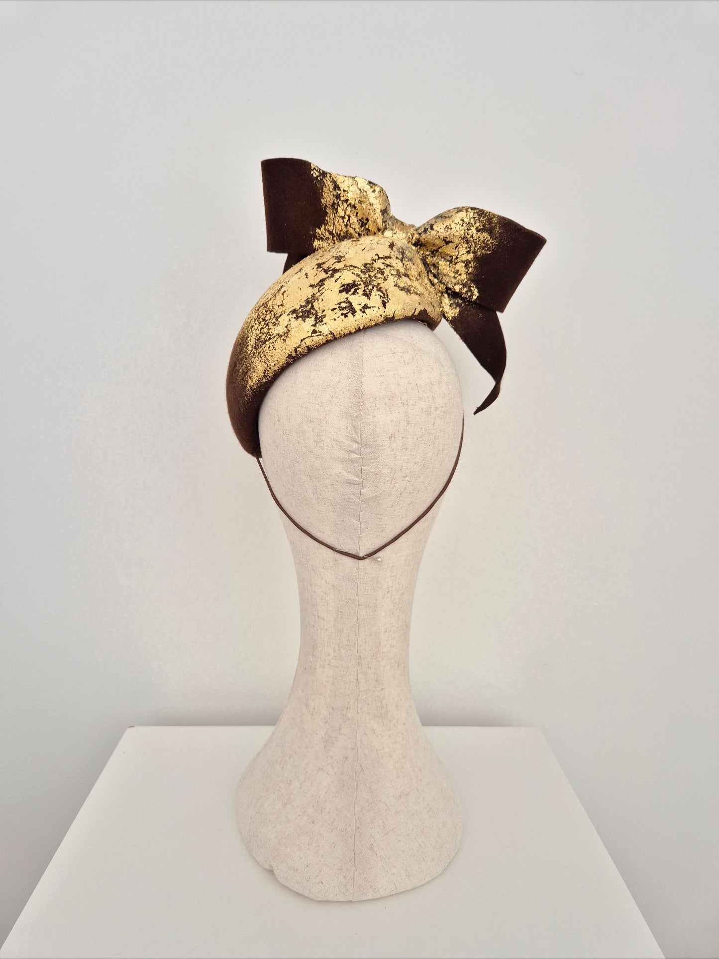 Miss Julia. Womens Chocolate brown felt headpiece with bow and gold foil detail