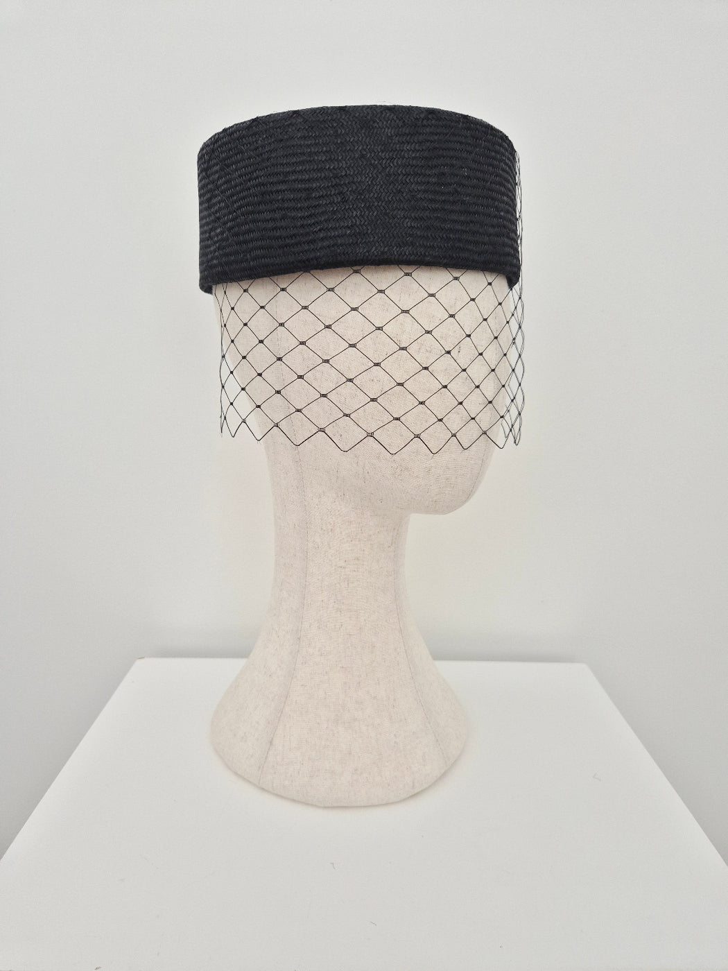 black straw pillbox headpiece with veiling side view