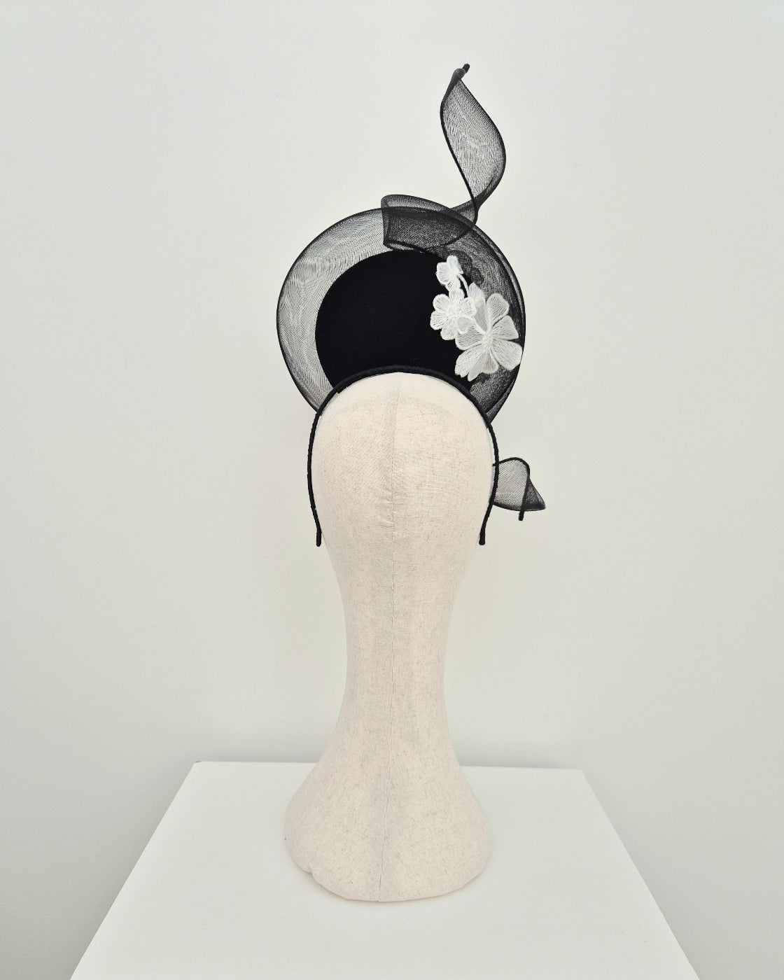 black percher headpiece with white floral lace back view