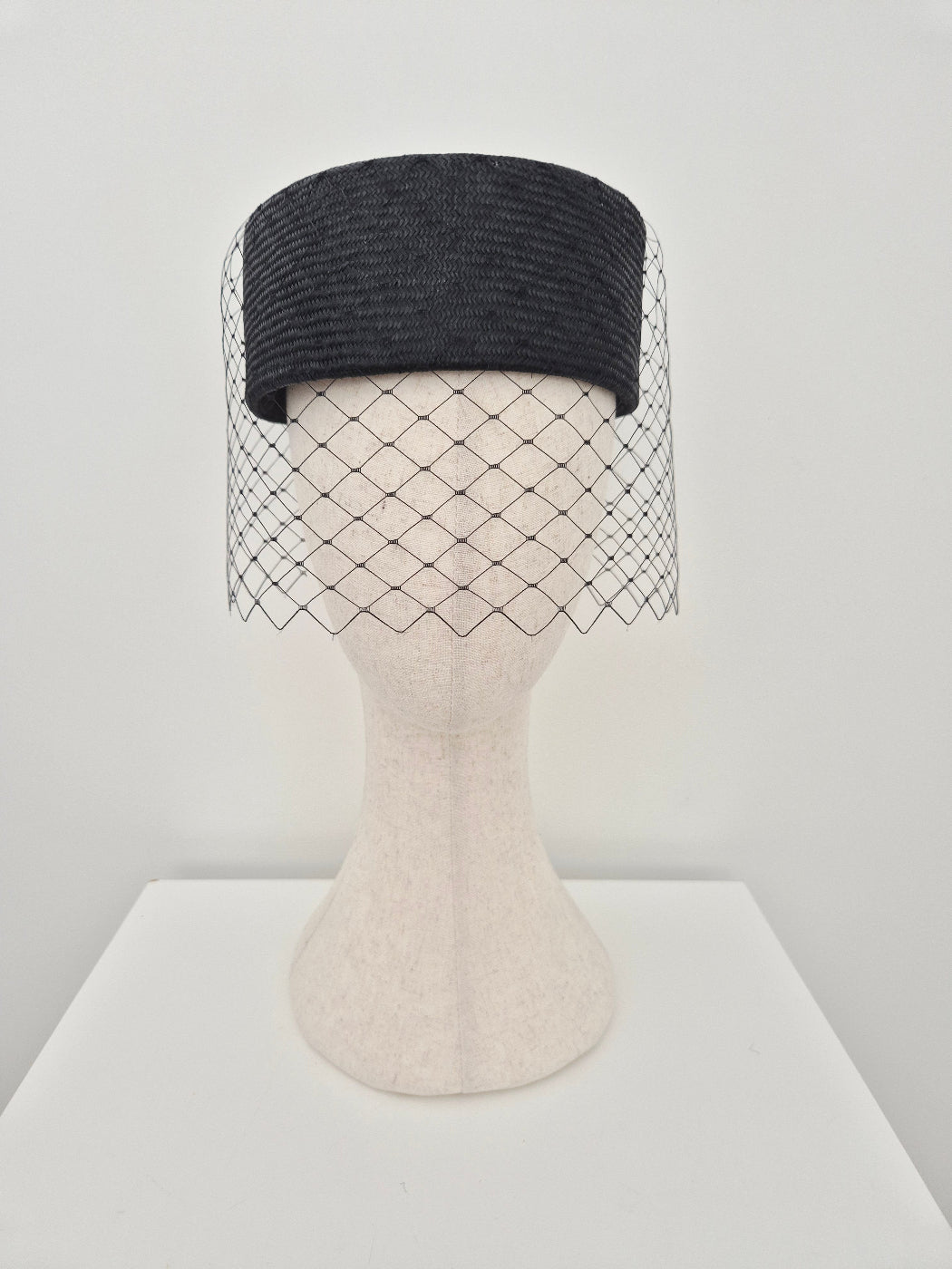 black straw pillbox with veiling