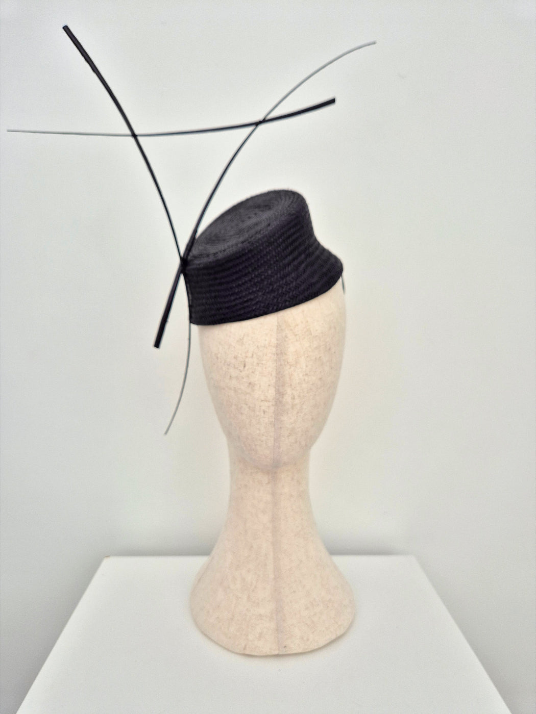 black straw slanted headpiece with quills