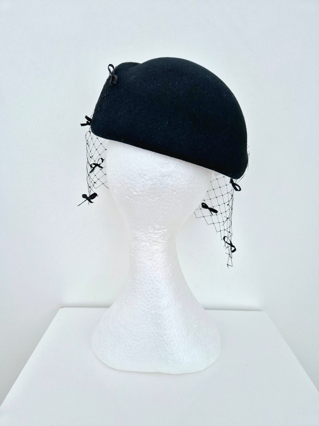 black wool felt headpiece with bows and veiling back view