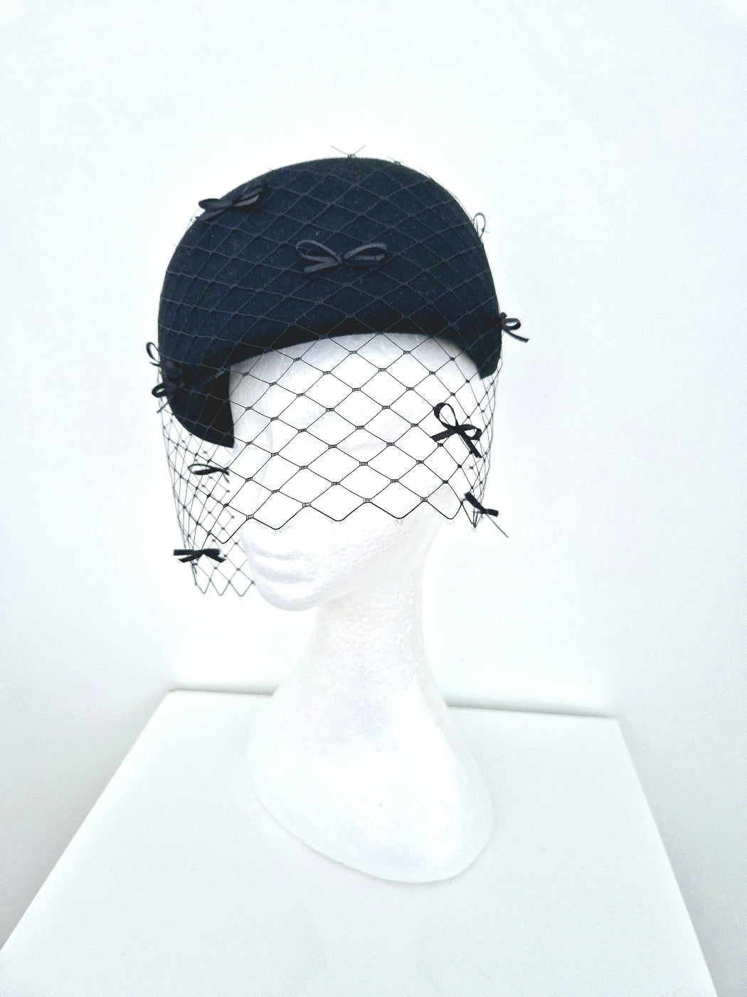 black wool felt headpiece with bows and veiling side view