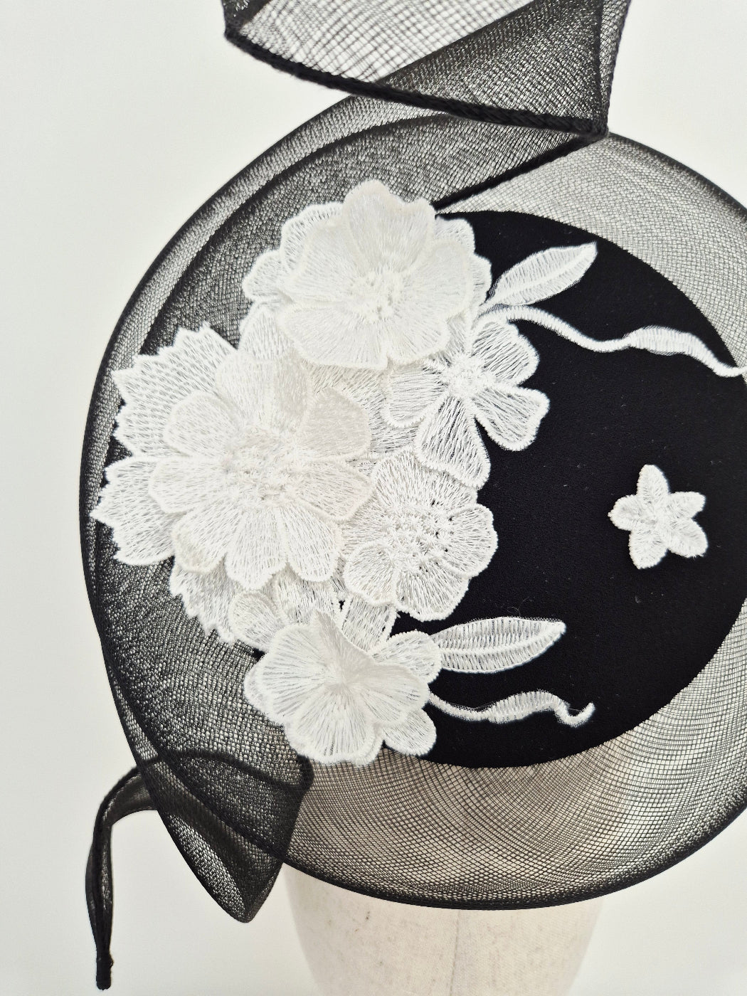 close up black and white floral lace percher headpiece
