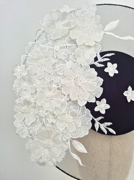 close up black percher headpiece with white floral lace